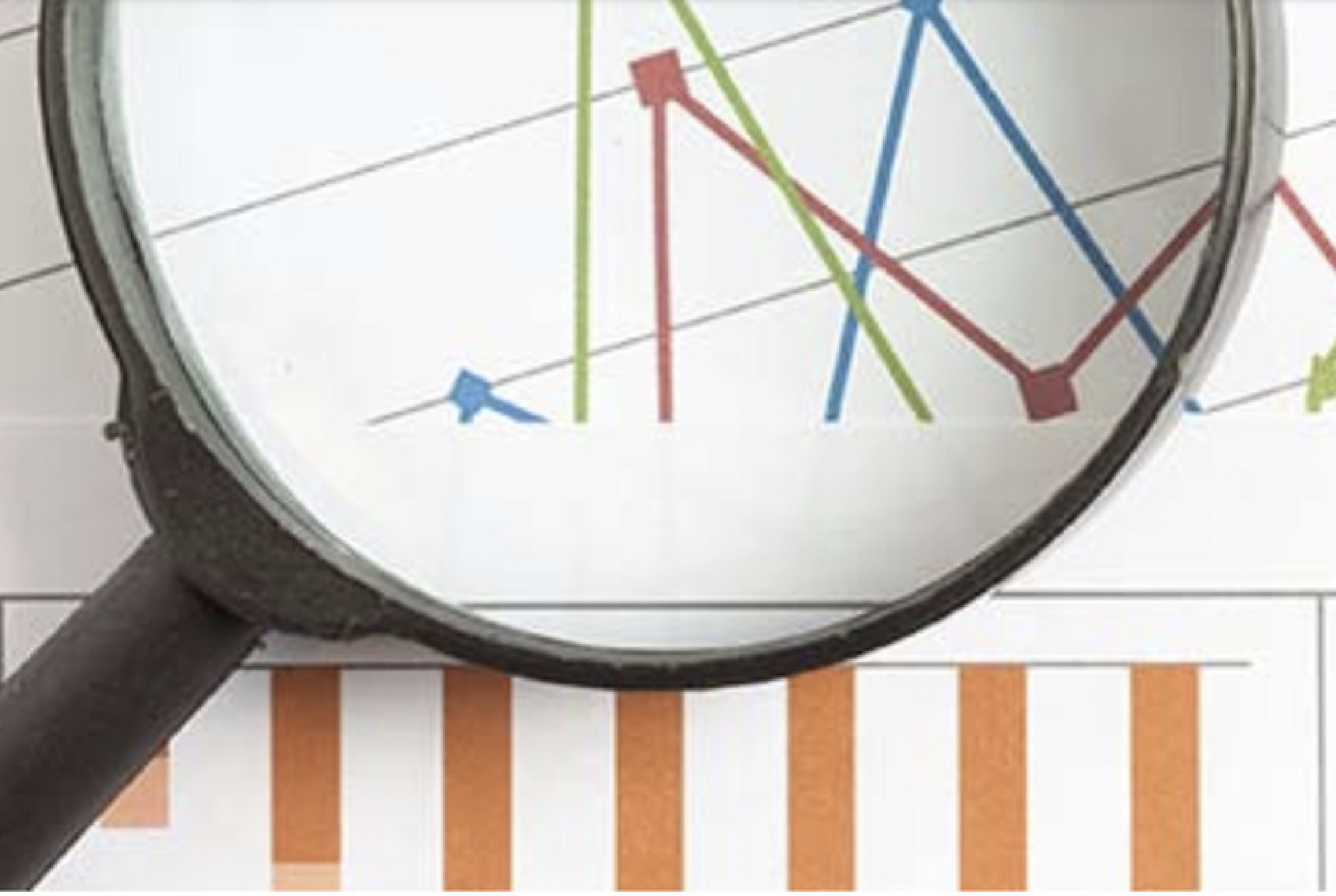 magnifying glass over financial charts